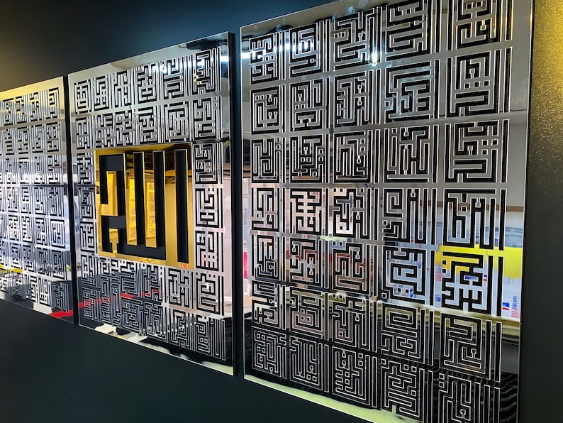 May include: Three silver metal wall panels with a geometric pattern. The center panel features the word "Allah" in gold lettering.