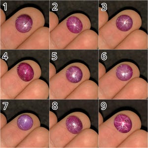 Könnte beinhalten: Eine Sammlung von neun einzelnen im Cabochon-Schliff geschliffenen Sternrubinen, die jeweils einen ausgeprägten sechsstrahligen Asterismus-Effekt aufweisen. Diese Edelsteine variieren in tiefen Rosa- und Rottönen und haben glatte, abgerundete Oberflächen.