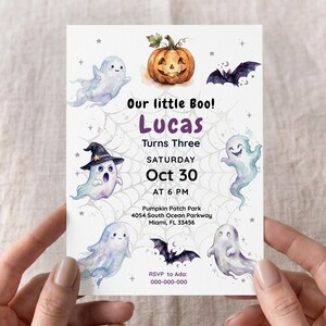 Puede incluir: Una tarjeta de invitación de Halloween blanca con ilustraciones en acuarela de fantasmas, una calabaza y murciélagos sobre un fondo de telaraña. El texto incluye Our little Boo! Lucas Turns Three, Saturday Oct 30 at 6 PM, Pumpkin Patch Park, 4054 South Ocean Parkway, Miami, FL 33456, y RSVP to Ada: 000-000-000.