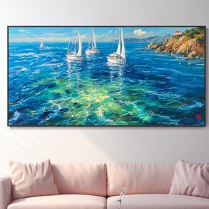 May include: An oil painting showing sailboats on a turquoise sea under a blue sky. The artwork features three prominent sailboats with white sails, set against a coastal landscape with a small building on a cliff. The painting is framed in black.