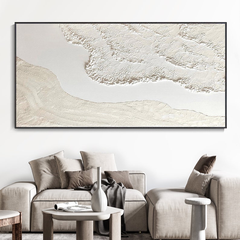 May include: Abstract art print with a white and cream color scheme. The print features a textured, layered design that resembles waves or clouds.