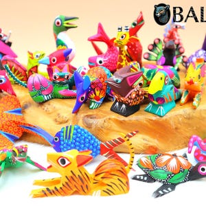 May include: A collection of colorful, hand-painted wooden animal figurines, including a turtle, a fish, a bird, a cat, and a dog. The figurines are all brightly colored and have intricate details. The figurines are arranged on a wooden surface.