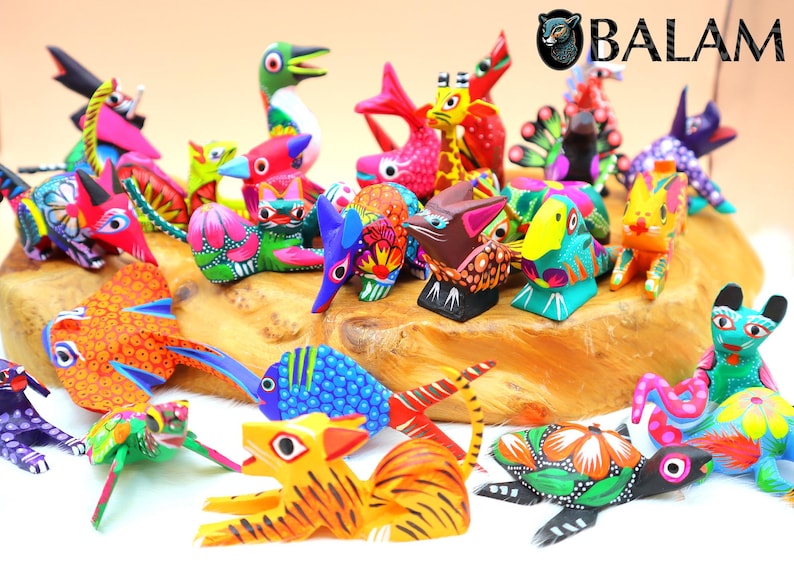 May include: A collection of colorful, hand-painted wooden animal figurines, including a turtle, a fish, a bird, a cat, and a dog. The figurines are all brightly colored and have intricate details. The figurines are arranged on a wooden surface.