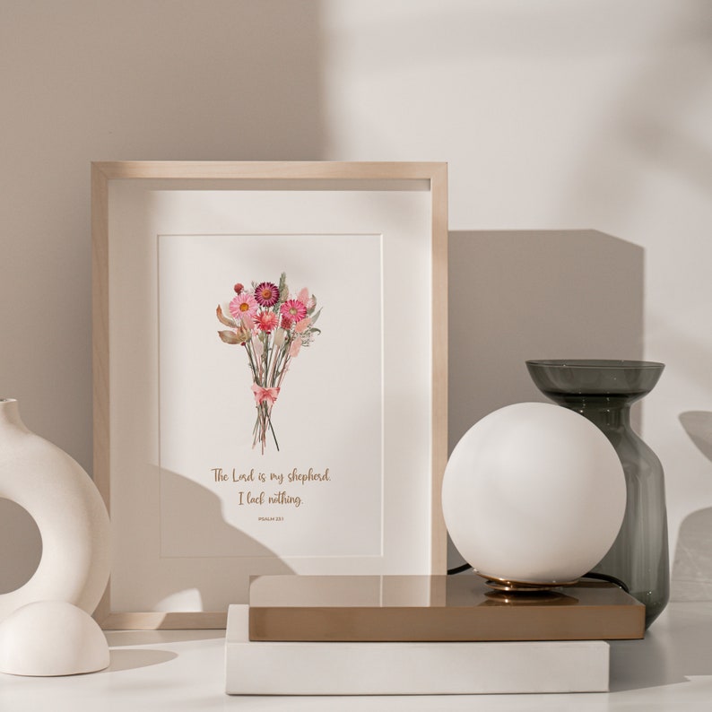 Puede incluir: Una impresi&oacute;n enmarcada con una ilustraci&oacute;n de acuarela de un ramo de flores rosas y blancas. El texto "The Lord is my shepherd, I lack nothing. Psalm 23:1" est&aacute; impreso debajo de las flores.