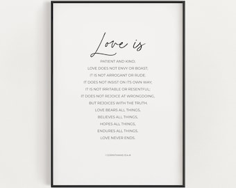 May include: Black and white typography print with the text "Love is" and a quote from 1 Corinthians 13:4-8 about the characteristics of love. The quote is printed in a simple, modern font.