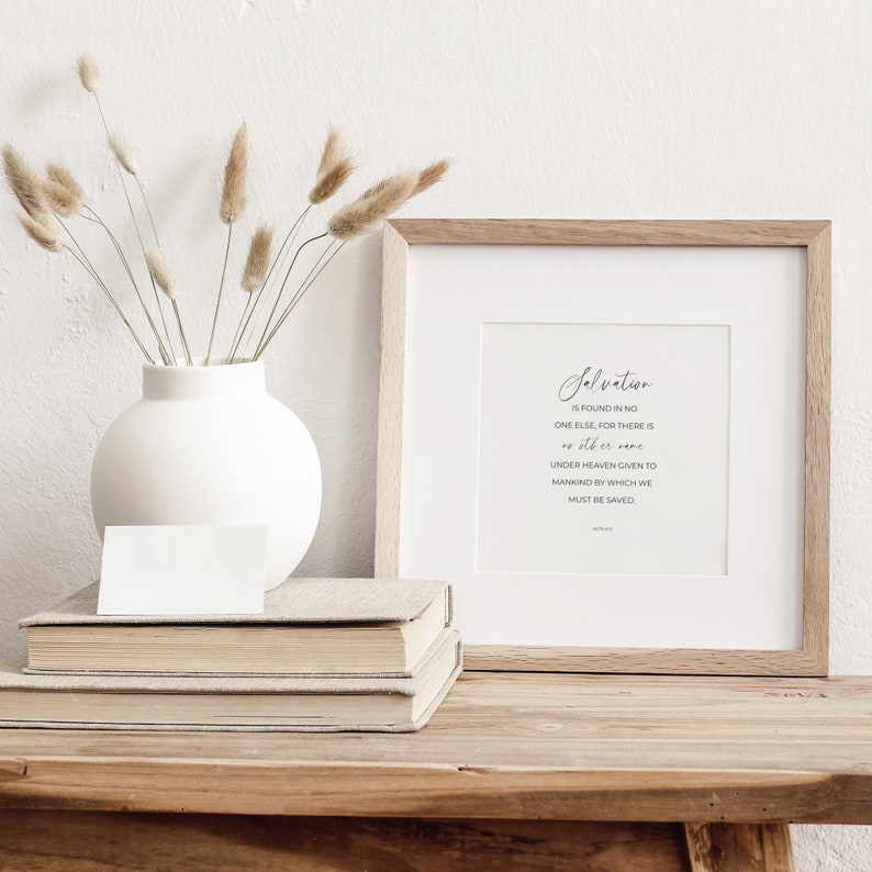 May include: A framed print with a white background and black text that reads "Salvation is found in no one else, for there is no other name under heaven given to mankind by which we must be saved."