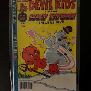 May include: A comic book titled "Devil Kids Starring Hot Stuff The Little Devil." The cover features a red devil character with a pitchfork, and a snowman with a top hat. The comic is in a protective sleeve.