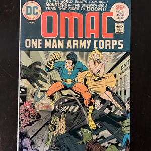 May include: A vintage comic book cover for "OMAC One Man Army Corps" features a dynamic illustration. The cover showcases a superhero in a blue and orange suit, a woman in a yellow dress, and various monsters. Text includes "DC Super-Stars" and "In the world that's coming--!"