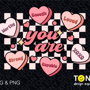 May include: A black and white checkered background with pink hearts that have positive affirmations written on them. The hearts say "worthy", "enough", "loved", "strong", "capable", and "xoxo". The text "you are" is written in large pink letters in the center of the image.