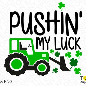 May include: Green tractor with a black front loader pushing a pile of green shamrocks. The text "PUSHIN' MY LUCK" is above the tractor.