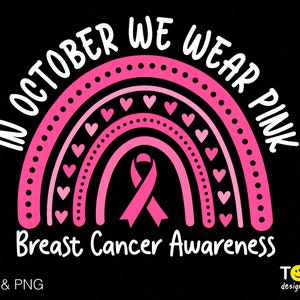 May include: A black graphic design with the text "IN OCTOBER WE WEAR PINK" and "Breast Cancer Awareness". The design features a pink ribbon and a pink rainbow with hearts and dots.