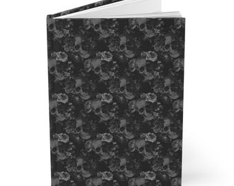 May include: Black and white journal with a skull and floral pattern. The cover is a repeating pattern of skulls and flowers.