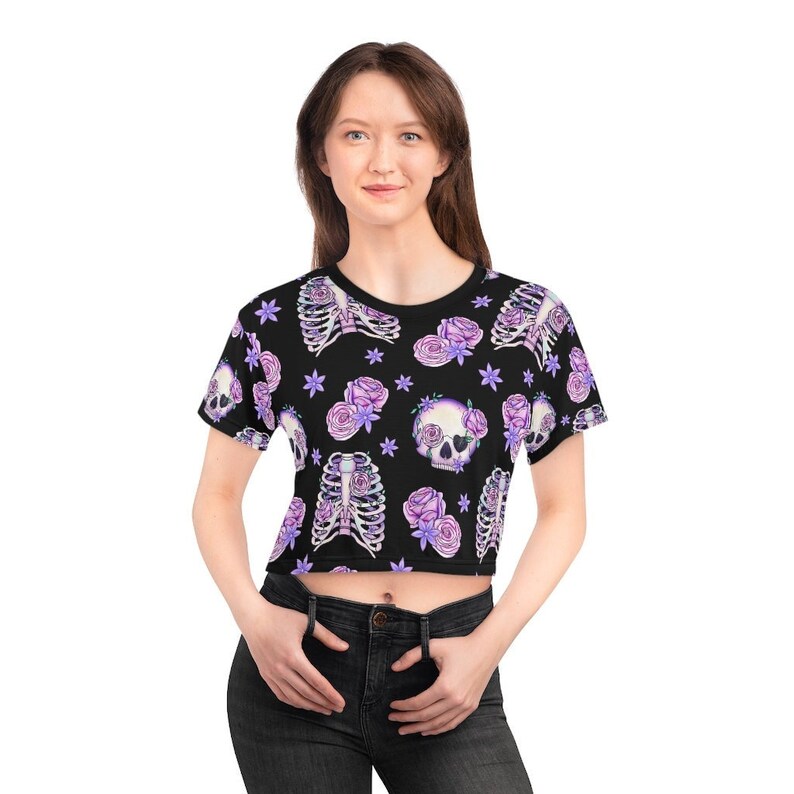 May include: Black crop top with a floral print featuring purple roses, skulls, and ribcages.