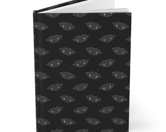 May include: Black journal with a white repeating pattern of vampire fangs and lips.