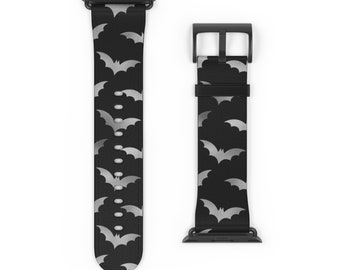 May include: Black Apple Watch band with a silver bat pattern.
