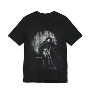 May include: Black t-shirt with a graphic print of a woman in a black hooded cloak holding a skull. The graphic is in shades of gray and white and has a distressed, vintage look. The text "NORMAL IS DULL" is printed in white below the graphic.