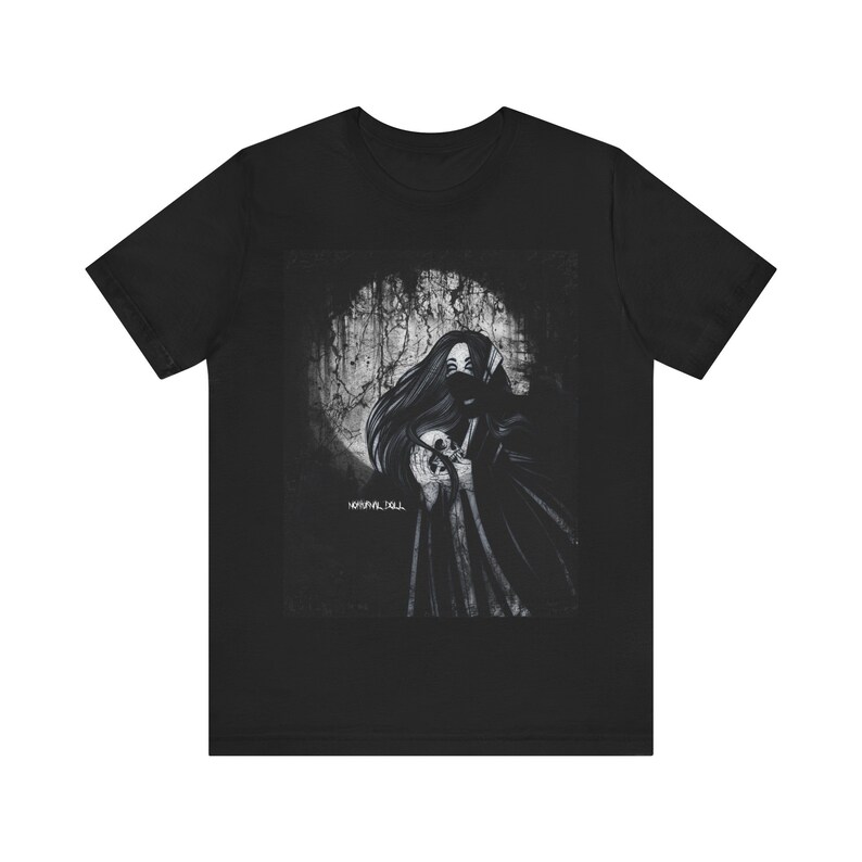 May include: Black t-shirt with a graphic print of a woman in a hooded cloak holding a skull. The background is a distressed, textured design with a moon.