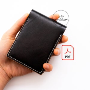 May include: A black leather wallet with white stitching around the edges. The wallet is held in a hand against a white background. A PDF icon is in the lower right corner. The logo for LEAP LEATHER CRAFT NEW ZEALAND is in the upper right corner.