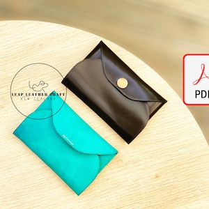 May include: Two leather envelope style wallets, one teal blue and one black, on a light wood surface. The text "LEAP LEATHER CRAFT NEW ZEALAND" is visible in the image. A PDF icon is in the upper right corner of the image.