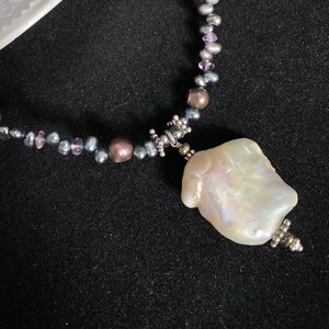 Stunning peacock pearl statement necklace with gorgeous baroque pearl pendant and amethyst and sterling silver accent beads.