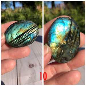 May include: Two smooth, polished labradorite stones with iridescent blue, green, and gold colors. The stones have a natural, oval shape.