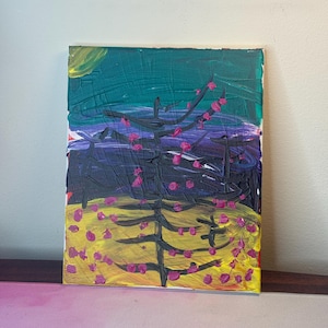 May include: Abstract painting on canvas featuring a tree with pink blossoms against a backdrop of yellow, purple, and teal. The artwork has a textured, brushstroke style, with a visible white border.