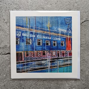 May include: A watercolor painting of a blue building with red accents and a floodlight. The building has a sign that reads "Goodison Park" and a crest with the number "1878".