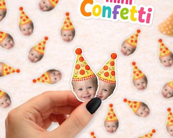 May include: Customized paper confetti featuring small die-cut faces of a child wearing a yellow pizza-patterned party hat with a red pom-pom. The text mini Confetti is displayed in colorful letters at the top. The confetti pieces are scattered.