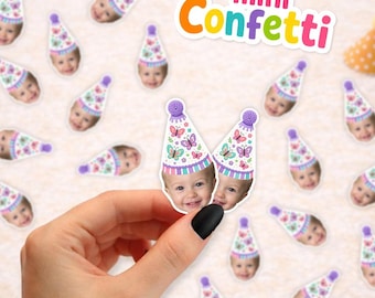 May include: A collection of small paper confetti pieces featuring a printed photograph of a child wearing a party hat decorated with colorful butterflies. The text mini Confetti is displayed in the upper right corner in a multi-colored font.