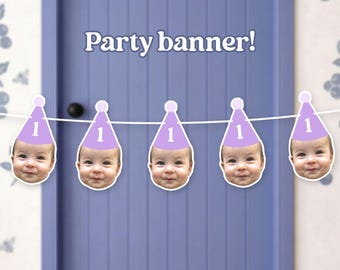 May include: A party banner featuring five cutouts of a baby's face, each wearing a light purple party hat with the number 1 printed in white. The cutouts are strung together on a white string. The text Party banner! is visible above the banner.