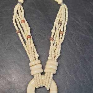 Bone beaded necklace with bone pendant