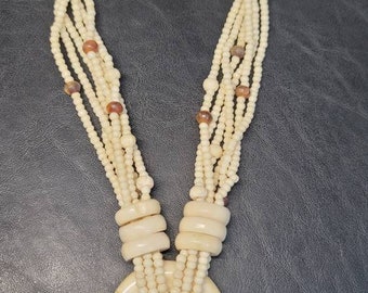 Bone beaded necklace with bone pendant