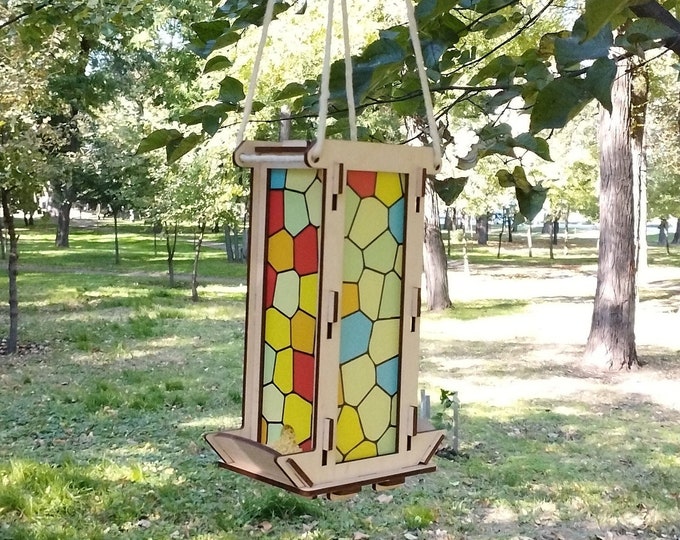 Bird feeders for the outdoors with acrylic stained glass sides.