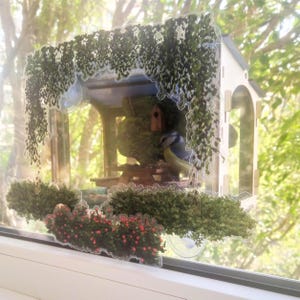 Bird feeder window. A cozy place for songbirds on your window. Unique window decoration in the style of a diorama.