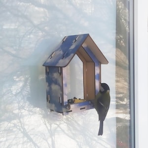 Window bird feeder with a print of the sky and clouds. Handmade from plywood in DIY style.