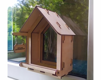 Wooden handmade bird feeder on the windows - a unique outdoor decor and an individual gift for nature lovers