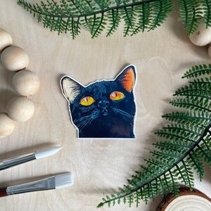 Adesivo brilhante de Halloween com um gato preto chamado abóbora