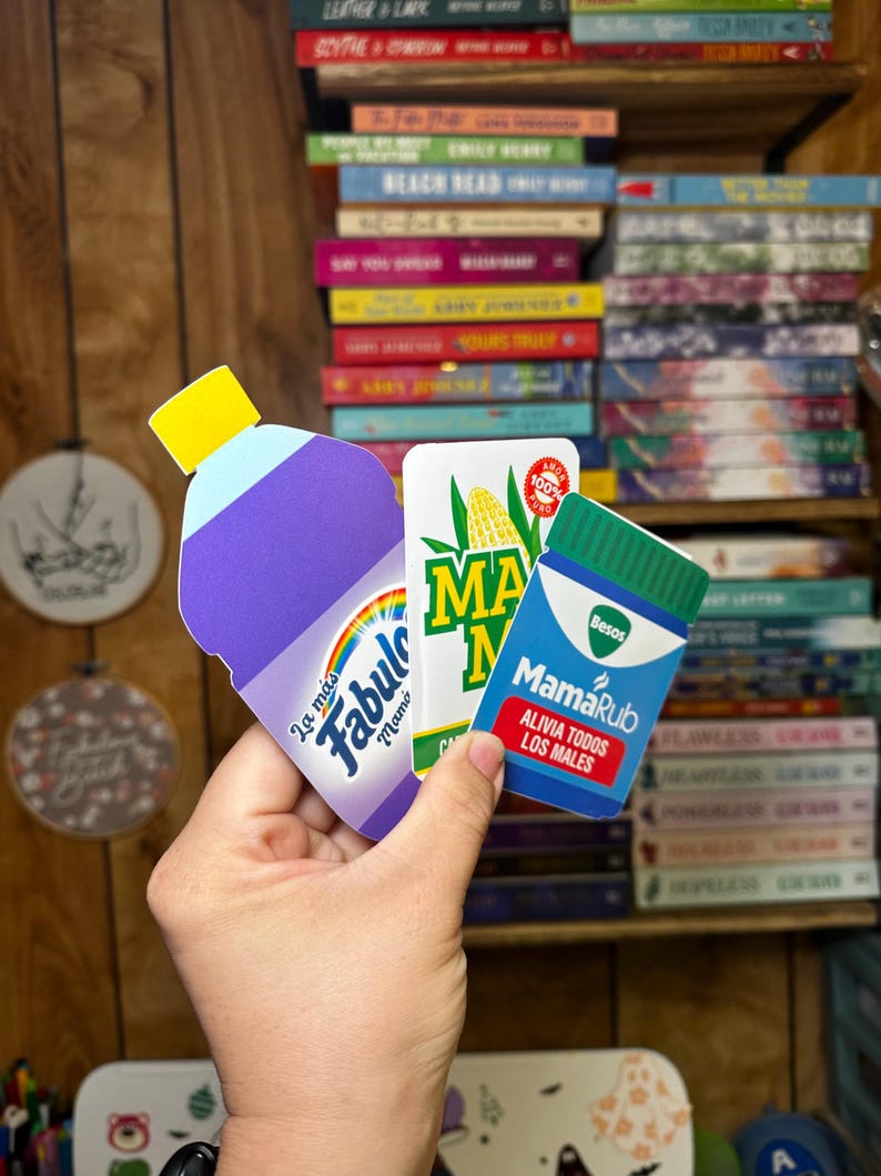 May include: Three colorful product labels, one for a purple cleaning product called "Fabuloso", one for a yellow corn product called "Maiz", and one for a green medicine product called "MamaRub".