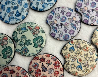 May include: Set of 8 round car coasters with various Disney character designs. The coasters feature a variety of colors and patterns, including blue, green, purple, yellow, and pink. Each coaster has a different design, featuring characters like Mickey Mouse, Minnie Mouse, Ariel, and more.