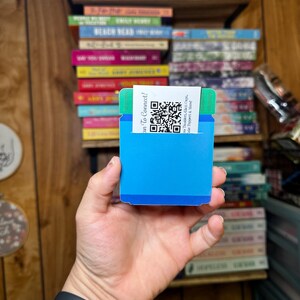 May include: A blue and green card with a QR code and the text "Scan To Connect!"  The text below the QR code reads "The Tumbler, Glass & Coffee Shoppe & More".