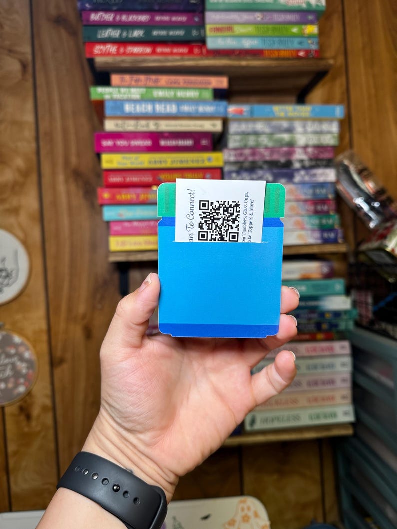 May include: A blue and green card with a QR code and the text "Scan To Connect!"  The text below the QR code reads "The Tumbler, Glass & Coffee Shoppe & More".