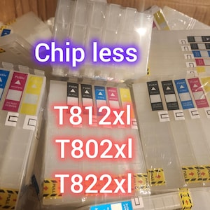 May include: Clear plastic ink cartridges labeled with "T812xl", "T802xl", and "T822xl". The text "Chip less" is also visible. The cartridges have colored labels and are packaged together.