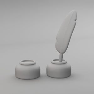 May include: A light gray inkwell set, featuring a small, round ink pot and a matching ink pot with a feather quill. The quill is upright, suggesting readiness for writing. The set is a classic writing accessory.