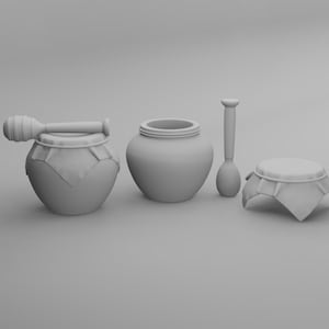 Puede incluir: Un conjunto de tarros de miel y utensilios de servicio de cerámica gris. El conjunto incluye un tarro de miel con un cucharón, un tarro, una cuchara y un plato pequeño cubierto. Los artículos están dispuestos sobre una superficie gris.