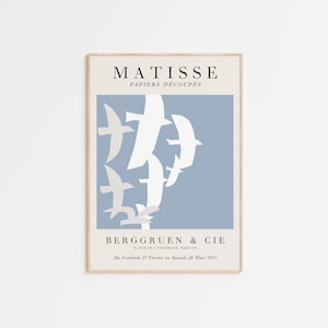 May include: A poster featuring a blue background with white paper cutouts of birds. The poster is titled "MATISSE PAPIERS D&Eacute;COUP&Eacute;S" and includes the text "BERGGRUEN & CIE 78, RUE DE L'UNIVERSITE, PARIS-VII Du Vendredi 27 F&eacute;vrier au Samedi 28 Mars 1953".