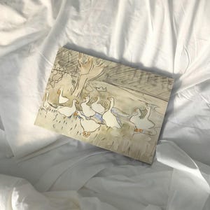May include: A watercolor painting of a group of white geese walking in a field. The geese are drawn in a simple, stylized manner, and the background is a soft, muted green.