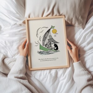 May include: A framed art print featuring a whimsical illustration of cats sailing in a green boat. The artwork includes a patchwork sail, a yellow sun, and the text "The Owl & the Pussycat went to sea, in a beautiful pea green boat."