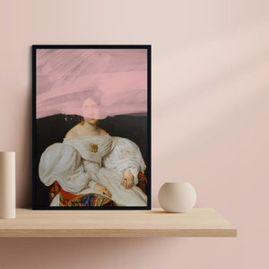 May include: A framed print of a woman in a white dress with a pink abstract design overlaying her face. The background is dark.