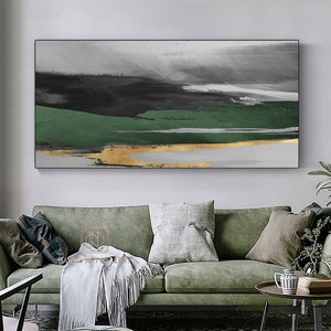 May include: Abstract landscape painting featuring green, gold, and grey colours. The painting depicts a layered landscape with a green field, a gold river, and a grey sky.