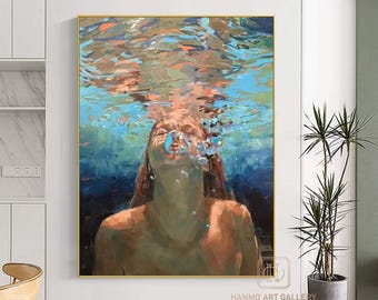 May include: An oil painting depicts a person underwater, exhaling bubbles. The artwork features a gold frame and is dominated by blues, oranges, and browns. The painting is signed "HANMO ART GALLERY" in the bottom right corner.